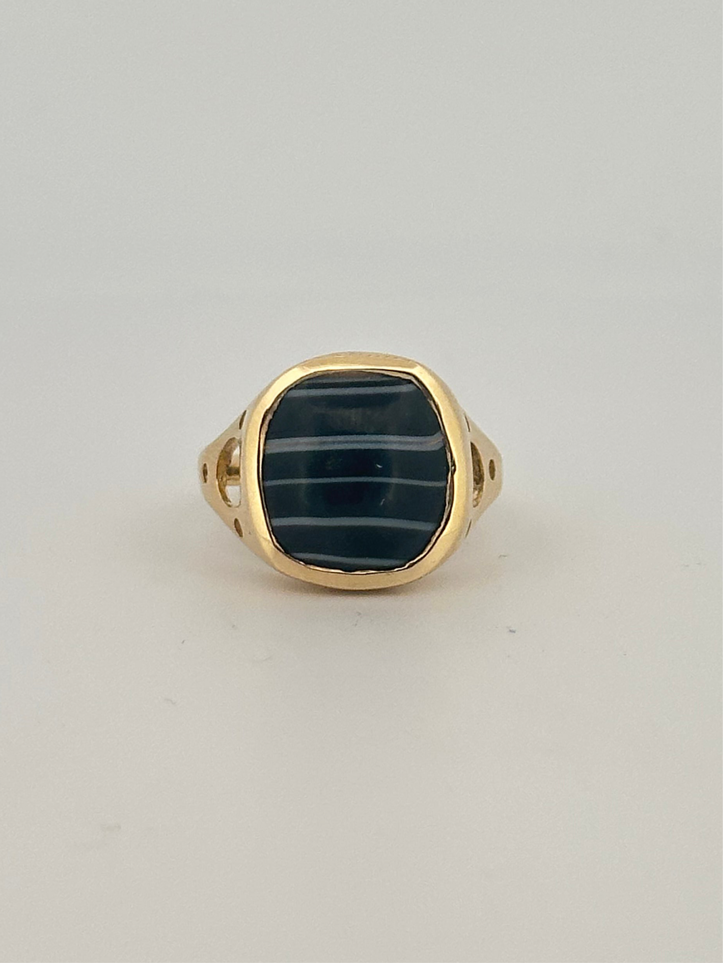 Black banded agate bezel set ring in 10k yellow gold