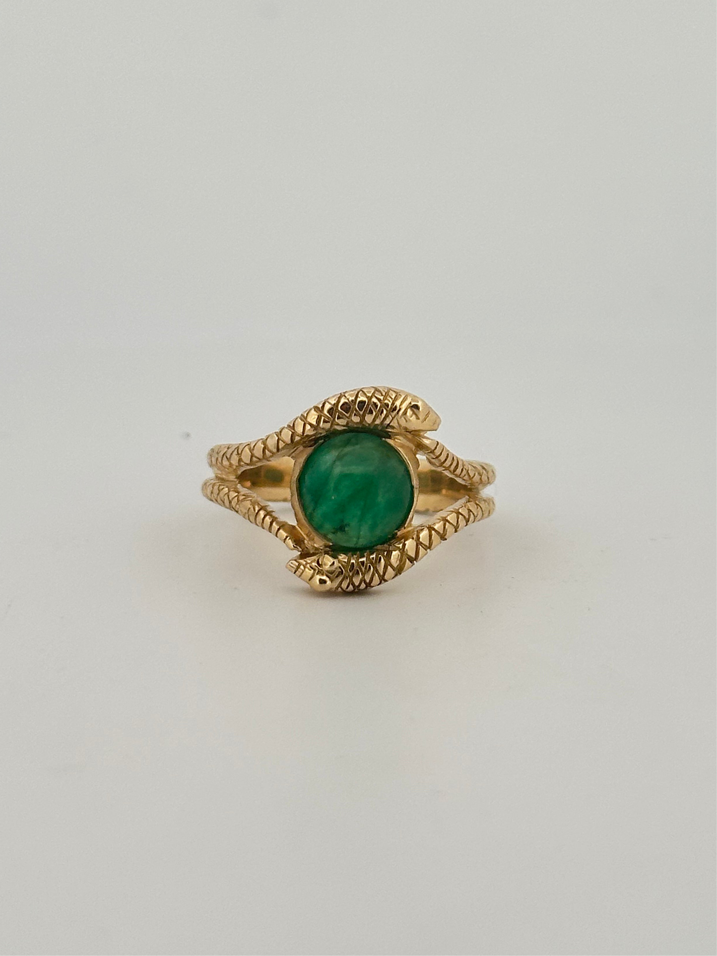 Double snake ring with natural emerald cabochon in 10k yellow gold