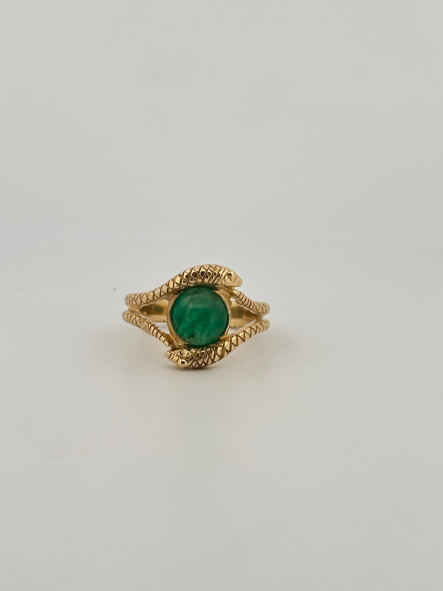 Double snake ring with natural emerald cabochon in 10k yellow gold